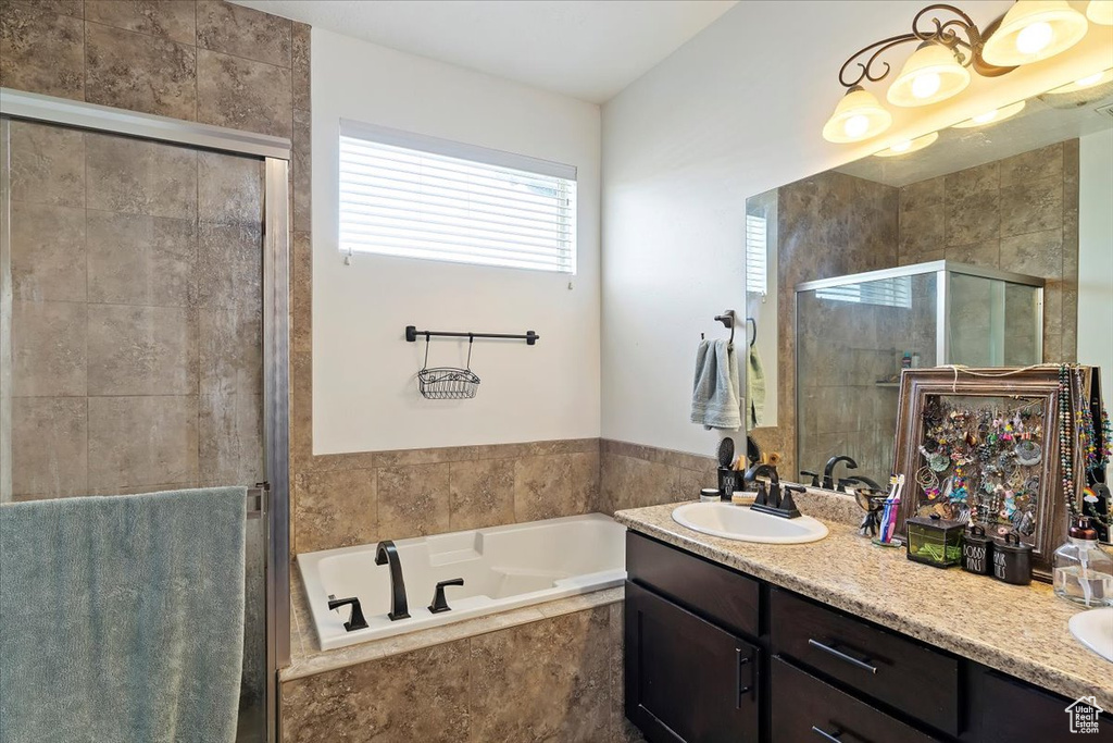 Bathroom featuring double sink vanity and plus walk in shower
