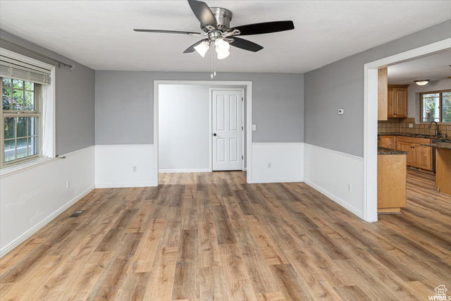 Spare room with wood-type flooring, ceiling fan, and sink