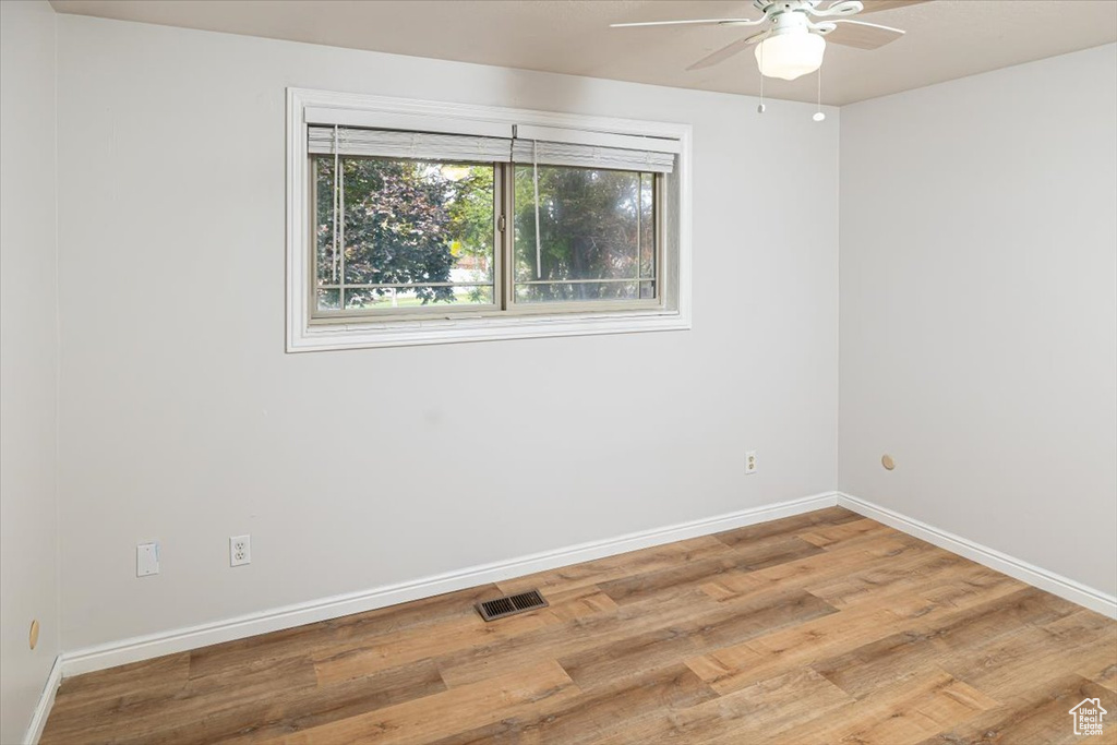 Spare room with hardwood / wood-style floors and ceiling fan