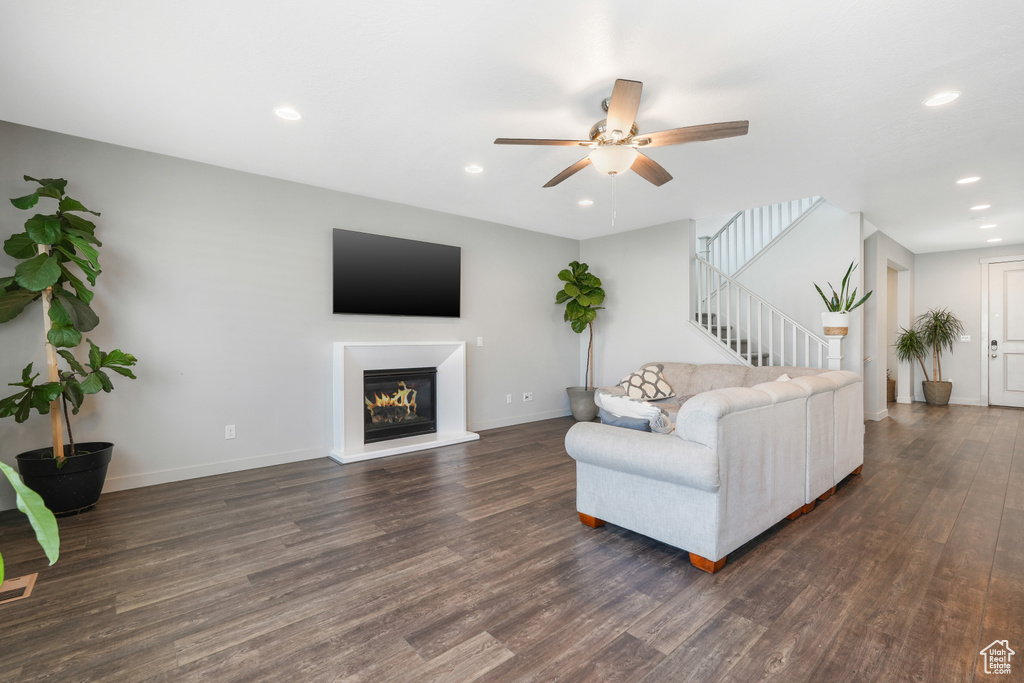 Living room featuring dark hardwood / wood-style flooring and ceiling fan