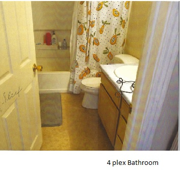 Full bathroom with tile floors, vanity, shower / bath combo, and toilet