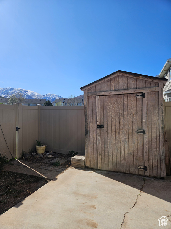 View of patio featuring a mountain view and a shed