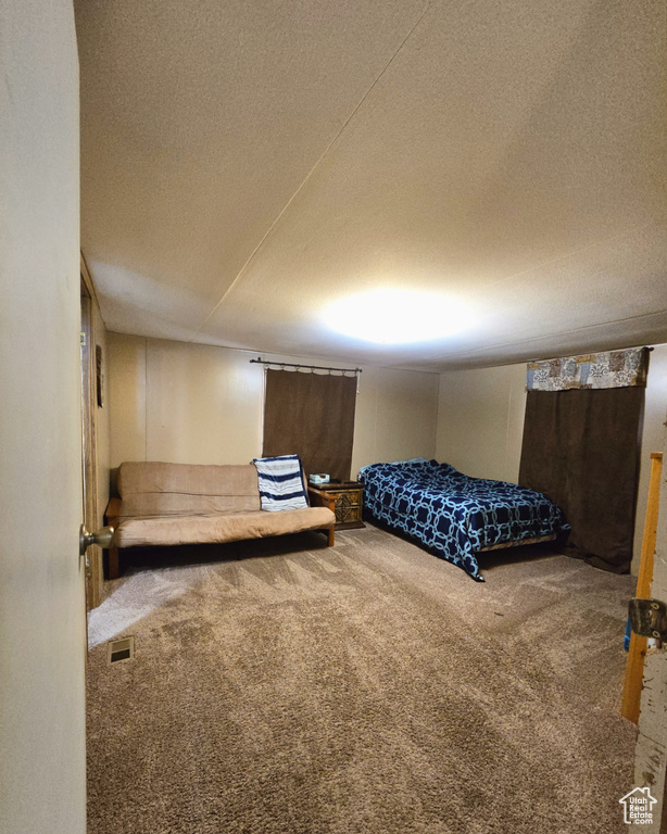 Bedroom with carpet and a textured ceiling