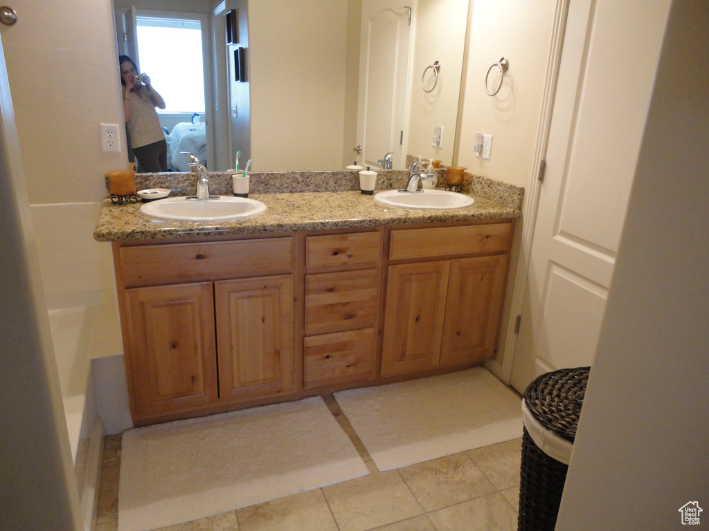 Bathroom featuring dual vanity and tile floors