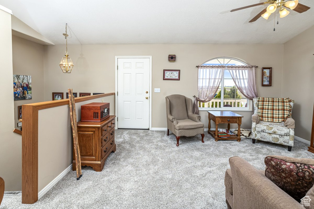 Living area with light colored carpet and ceiling fan