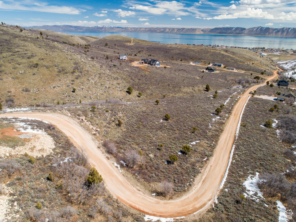 Birds eye view of property with a water and mountain view