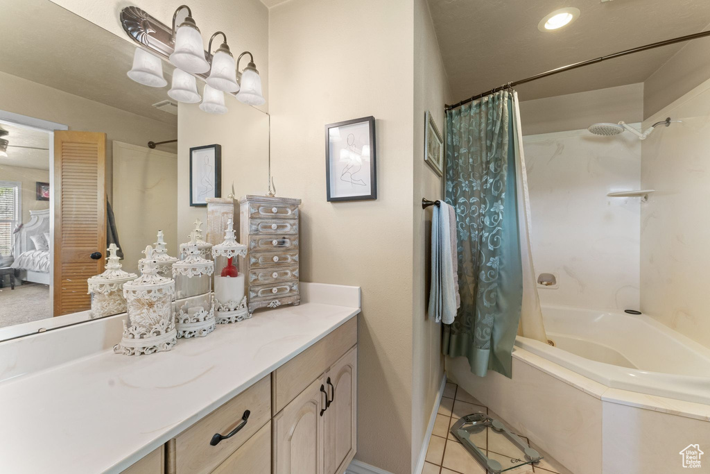 Bathroom with shower / tub combo with curtain, vanity, and tile floors
