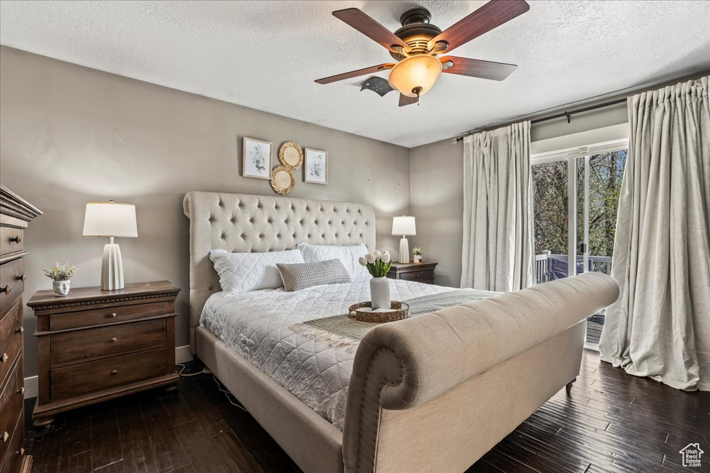 Bedroom featuring a textured ceiling, ceiling fan, access to outside, and dark wood-type flooring