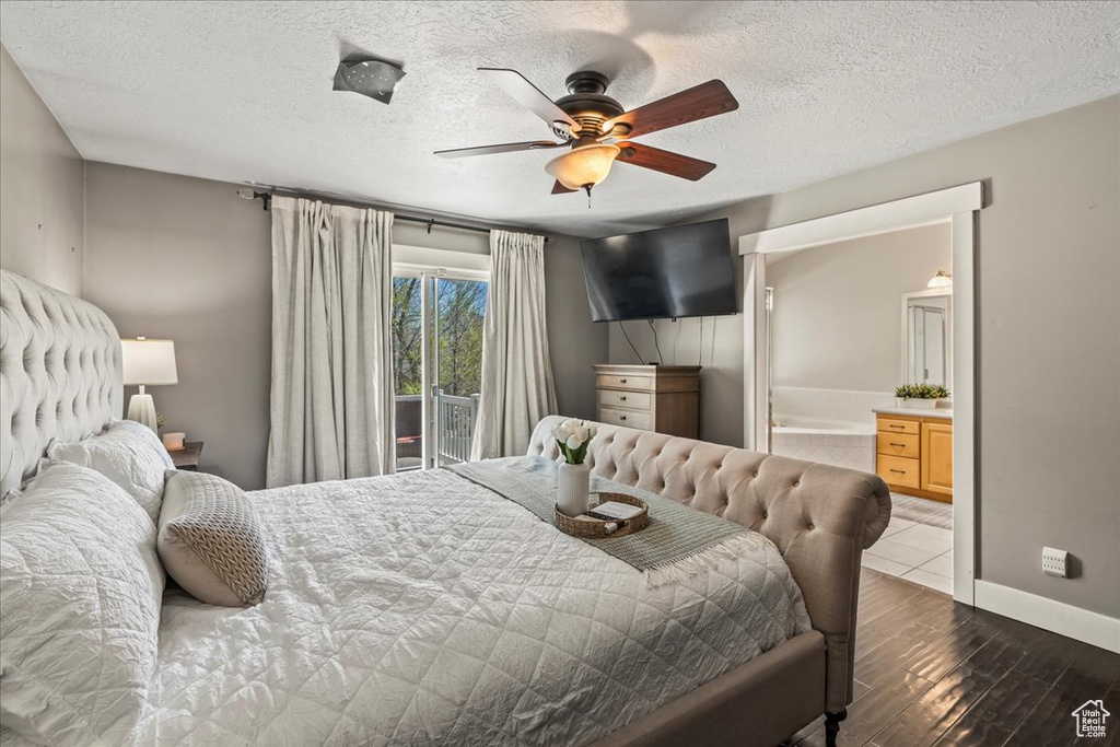 Bedroom with wood-type flooring, a textured ceiling, and ceiling fan