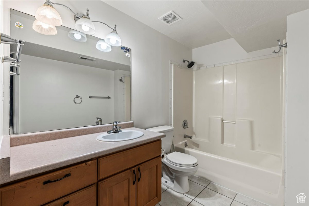 Full bathroom with vanity, bathing tub / shower combination, toilet, and tile flooring