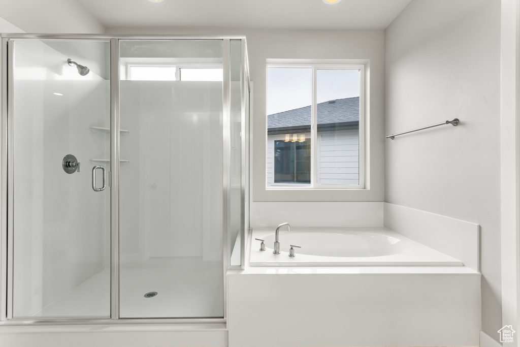 Bathroom with a healthy amount of sunlight and shower with separate bathtub