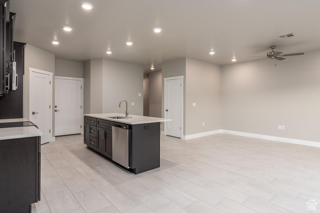 Kitchen featuring light tile flooring, stainless steel appliances, sink, a center island with sink, and ceiling fan