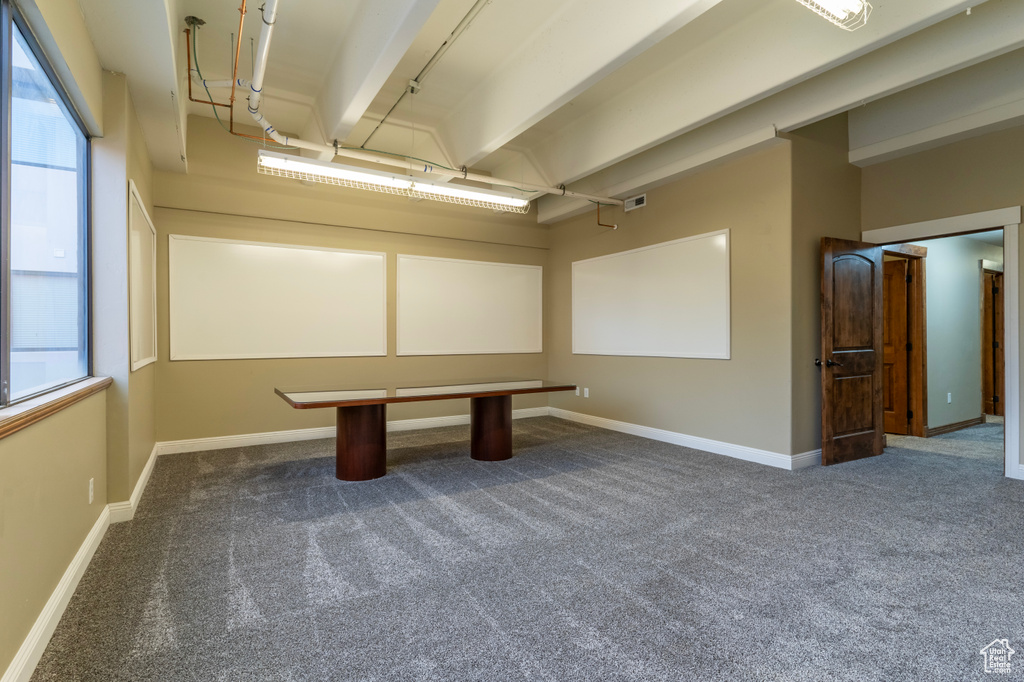 Rec room featuring a wealth of natural light and dark carpet