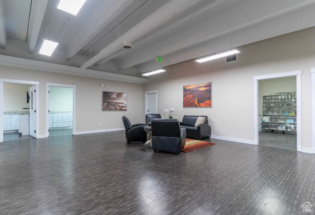 Interior space featuring dark hardwood / wood-style flooring and beamed ceiling