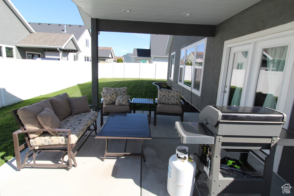 View of patio with area for grilling and an outdoor hangout area