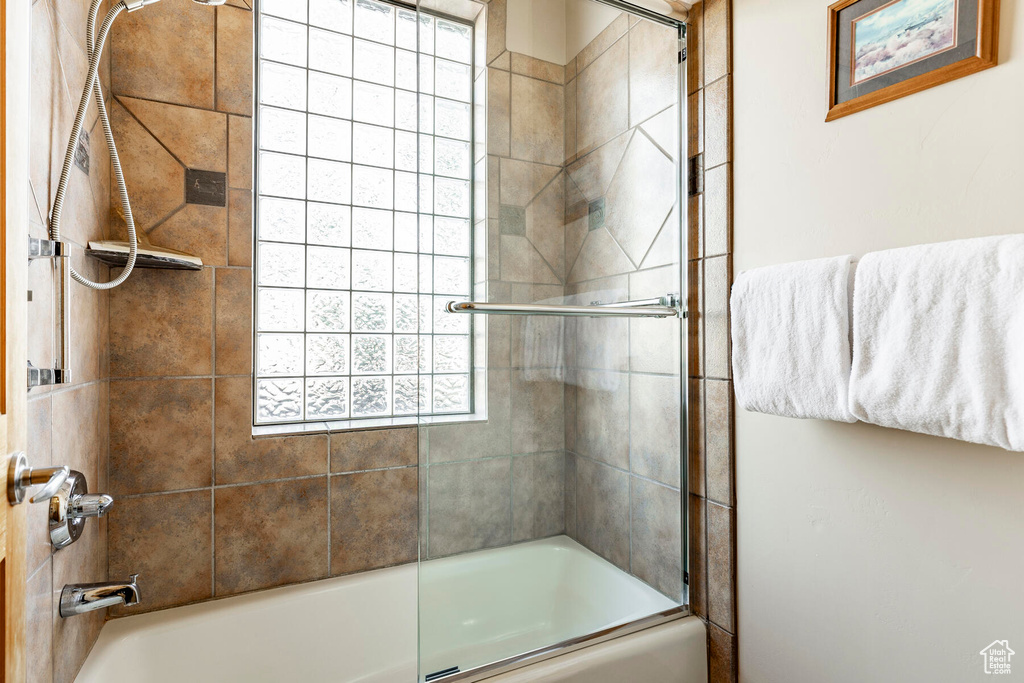 Bathroom featuring enclosed tub / shower combo