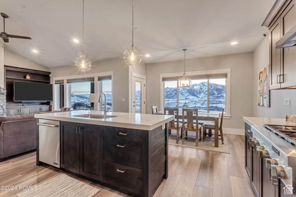 Kitchen with sink, a mountain view, light hardwood / wood-style flooring, and stainless steel appliances