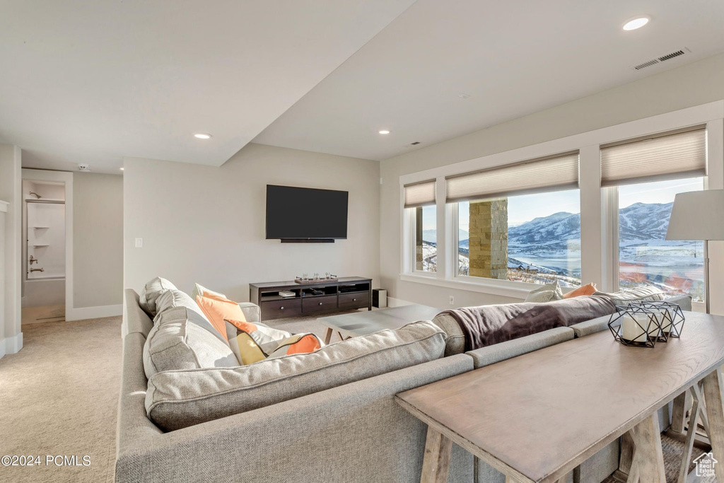 Carpeted living room with a mountain view