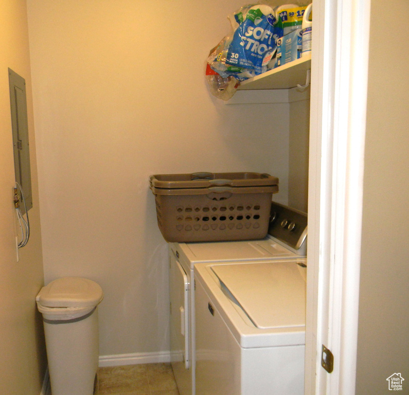 Laundry room featuring light tile floors and separate washer and dryer