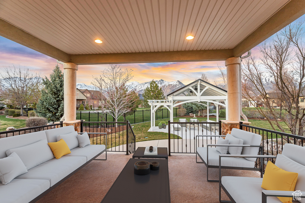 Patio terrace at dusk featuring a mountain view, an outdoor living space, and a gazebo