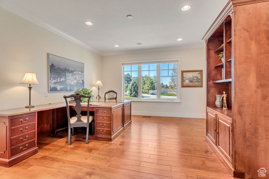 Office area featuring light hardwood / wood-style flooring and ornamental molding