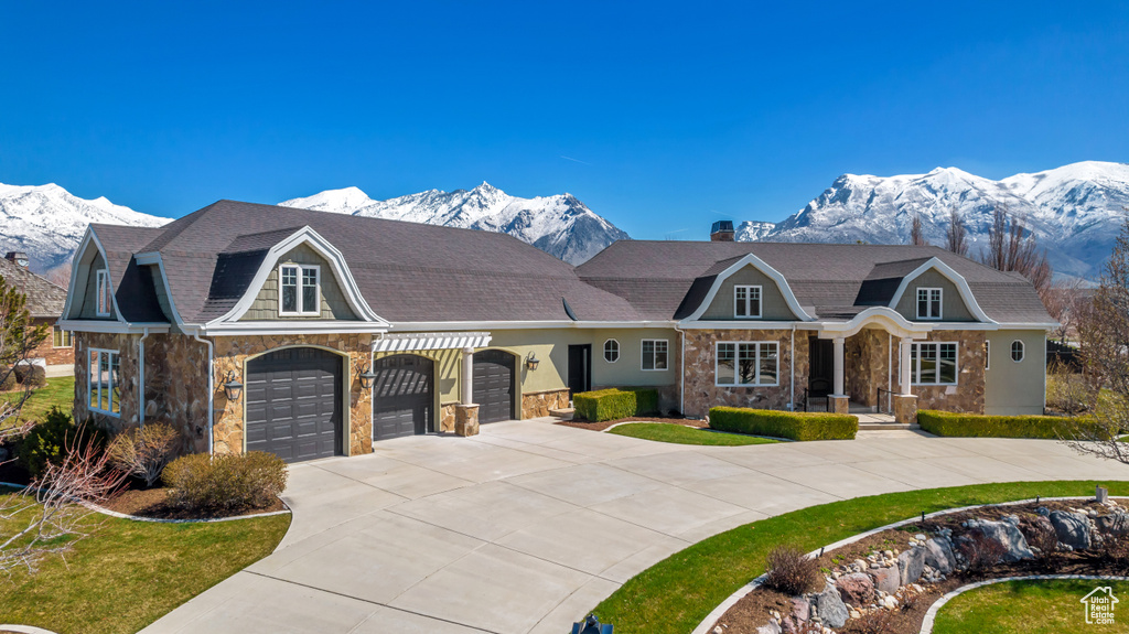 Single story home with a mountain view and a garage