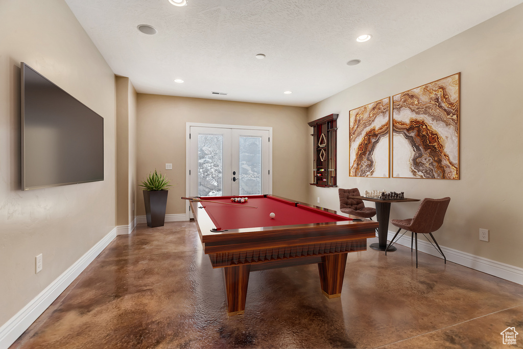 Rec room with french doors, billiards, and a textured ceiling