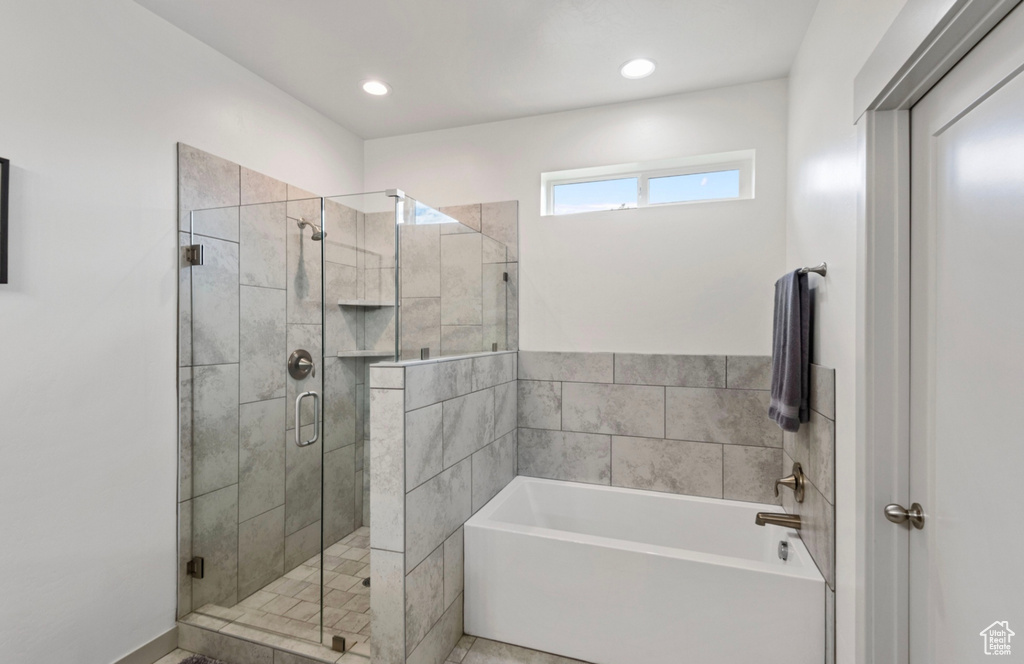 Bathroom featuring independent shower and bath and tile floors