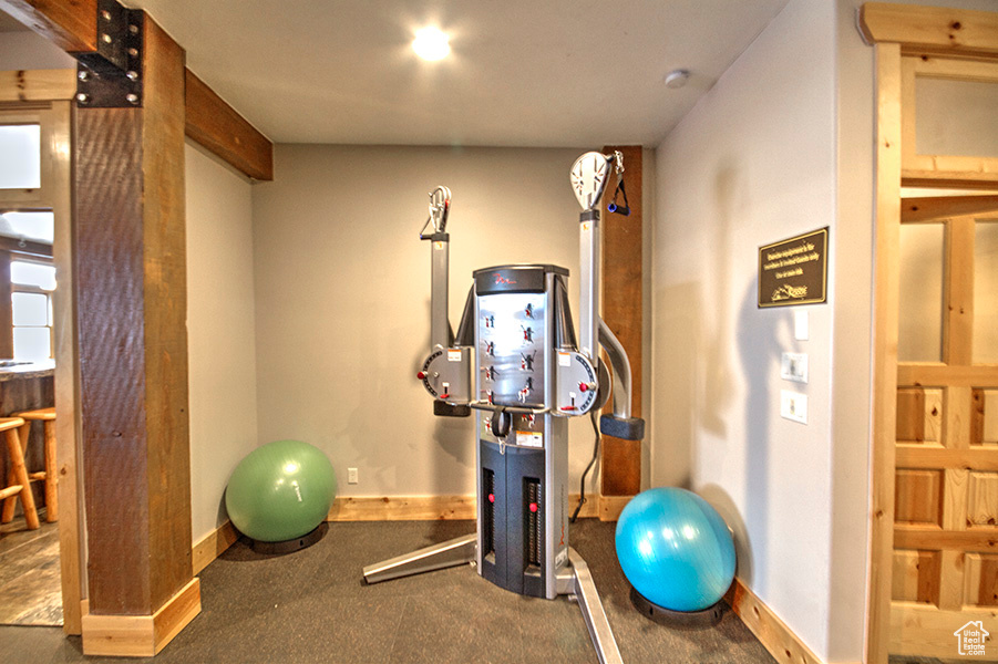 Exercise room featuring dark carpet