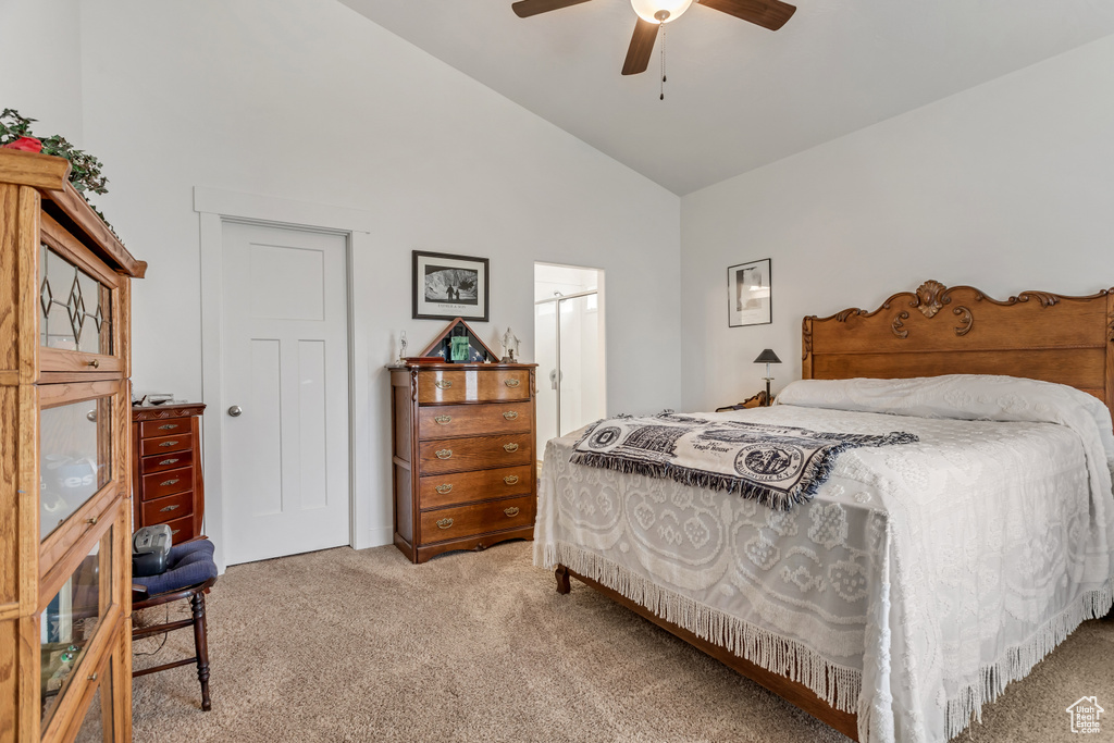Bedroom with high vaulted ceiling, light carpet, and ceiling fan