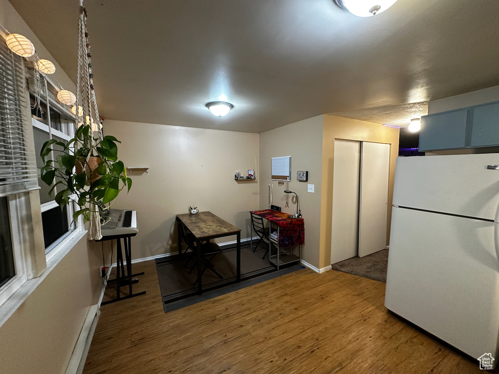 Interior space featuring hardwood / wood-style flooring and white fridge