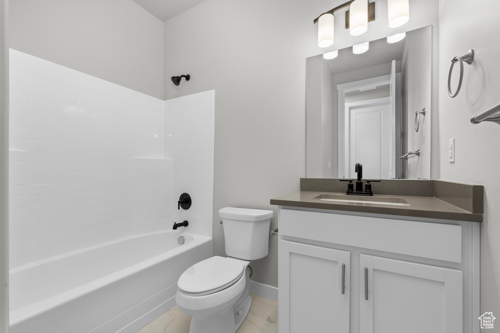 Full bathroom with oversized vanity, toilet, tile flooring, and bathing tub / shower combination