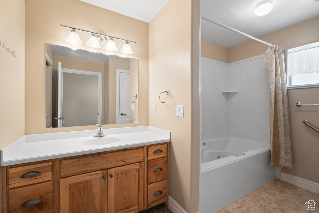 Bathroom with tile flooring, shower / bath combo, and vanity
