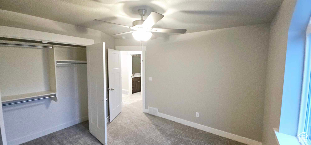 Unfurnished bedroom featuring a closet, ceiling fan, and carpet flooring