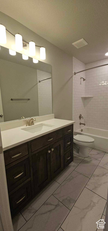 Full bathroom featuring tile flooring, oversized vanity, tiled shower / bath, and toilet