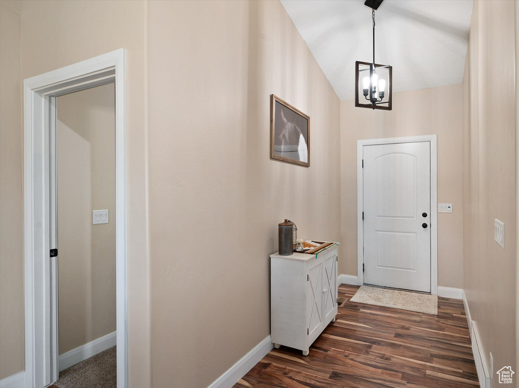 Entryway with an inviting chandelier and dark wood-type flooring