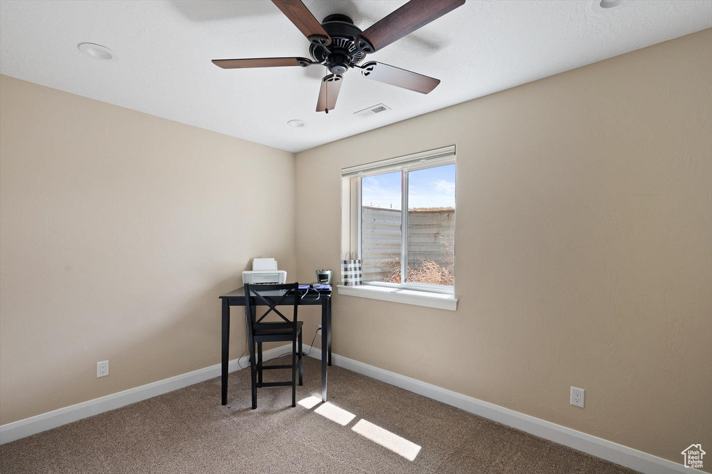 Office area featuring ceiling fan and carpet floors