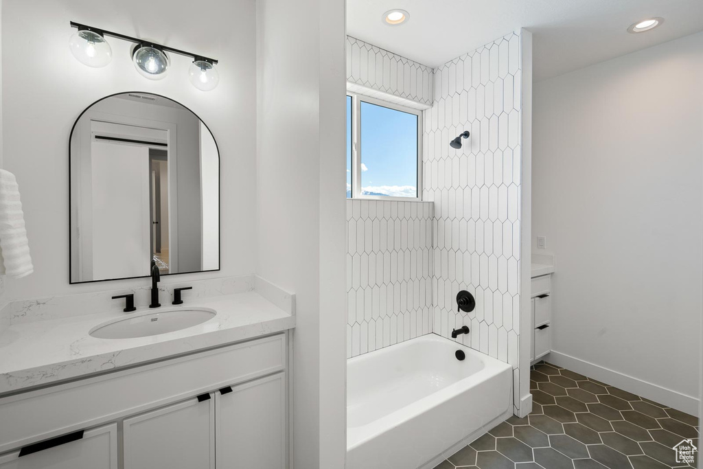 Bathroom with tile flooring, vanity, and tiled shower / bath combo