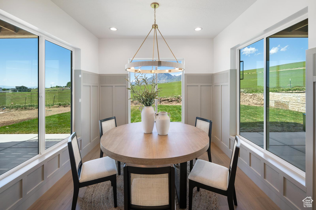 Dining area featuring a notable chandelier and wood-type flooring