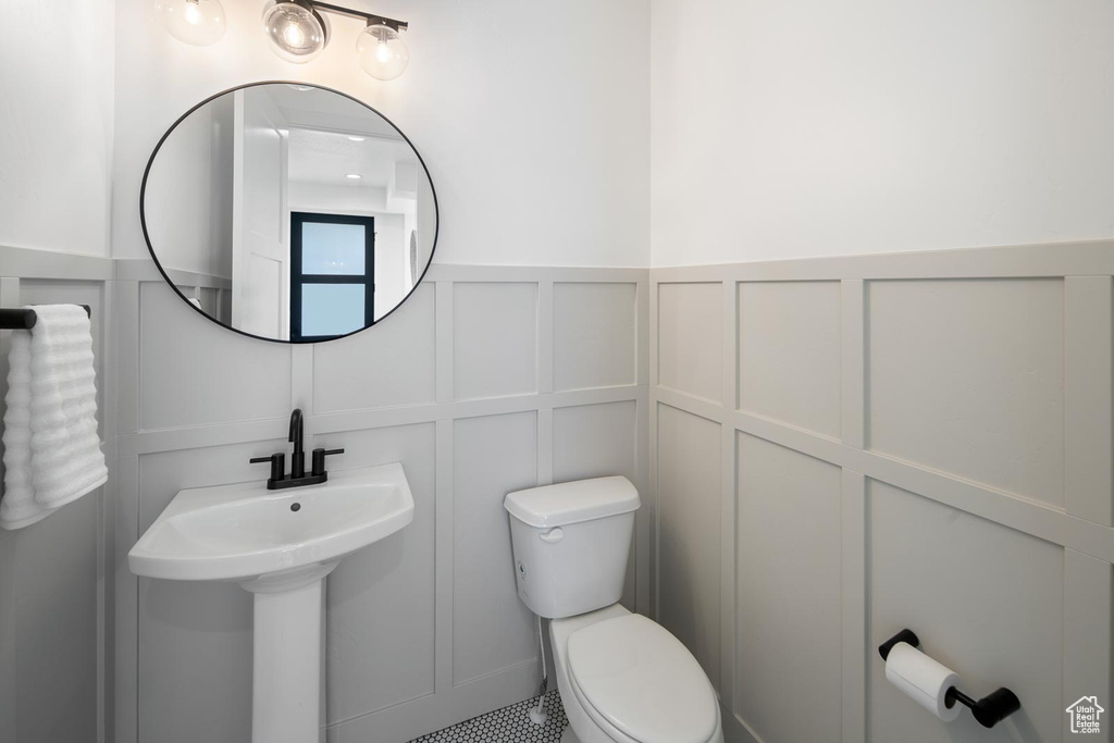 Bathroom featuring tile floors and toilet