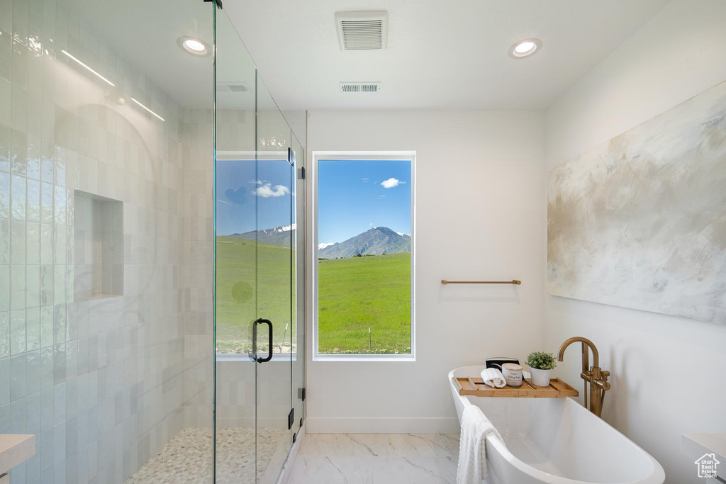 Bathroom featuring independent shower and bath, tile flooring, and a mountain view