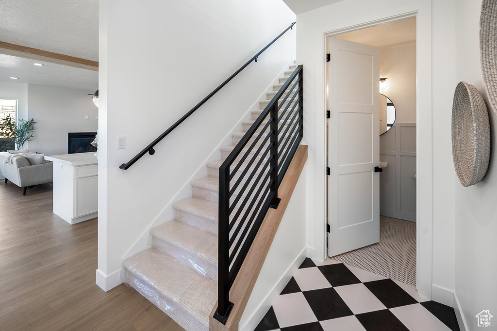 Stairway featuring light wood-type flooring