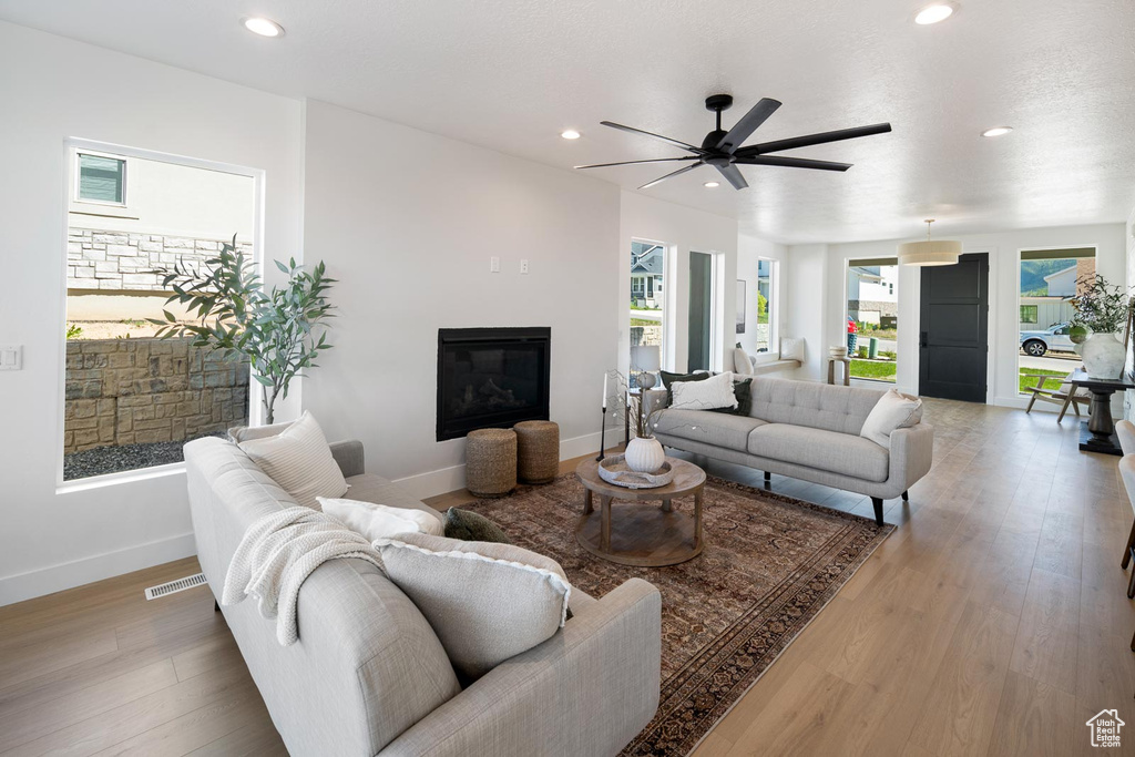 Living room with ceiling fan and wood-type flooring