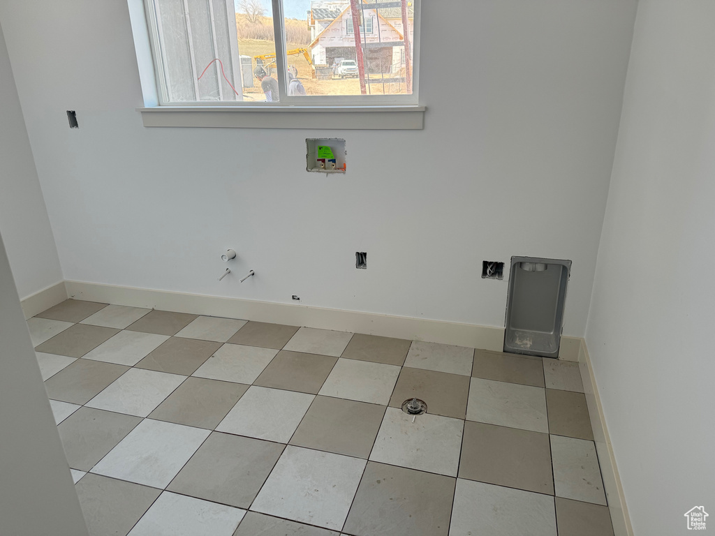 Laundry area with washer hookup and light tile floors