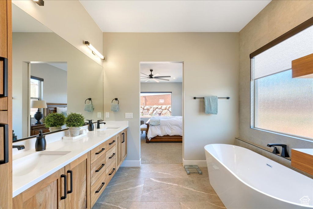 Bathroom featuring a healthy amount of sunlight, tile flooring, ceiling fan, and double sink vanity
