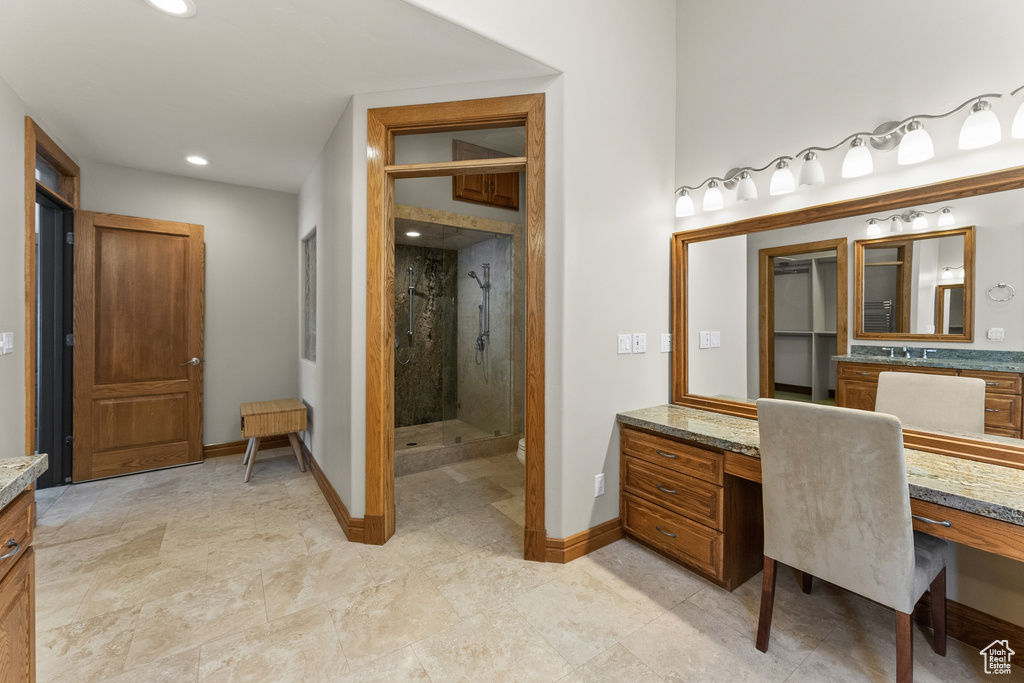 Bathroom with walk in shower, large vanity, and tile floors