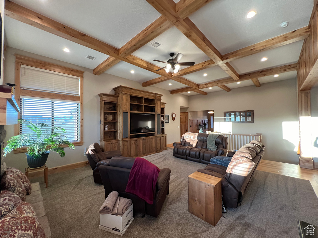 Living room featuring beamed ceiling, ceiling fan, and coffered ceiling