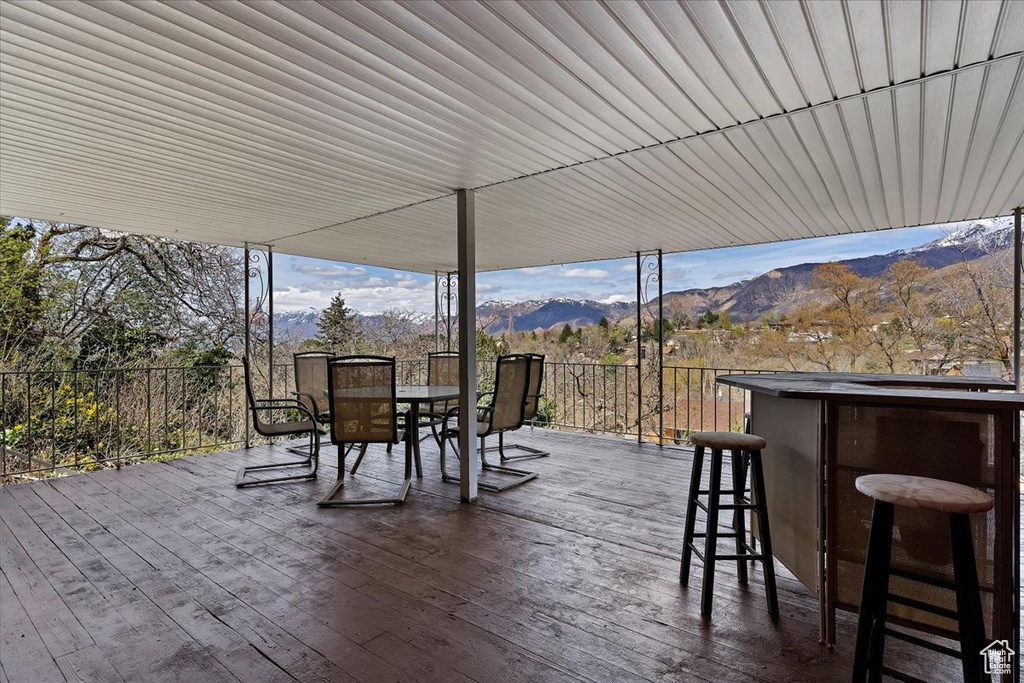 View of patio / terrace with a deck with mountain view