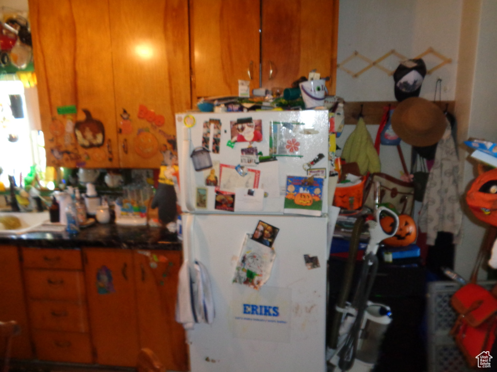 Kitchen featuring white refrigerator and sink