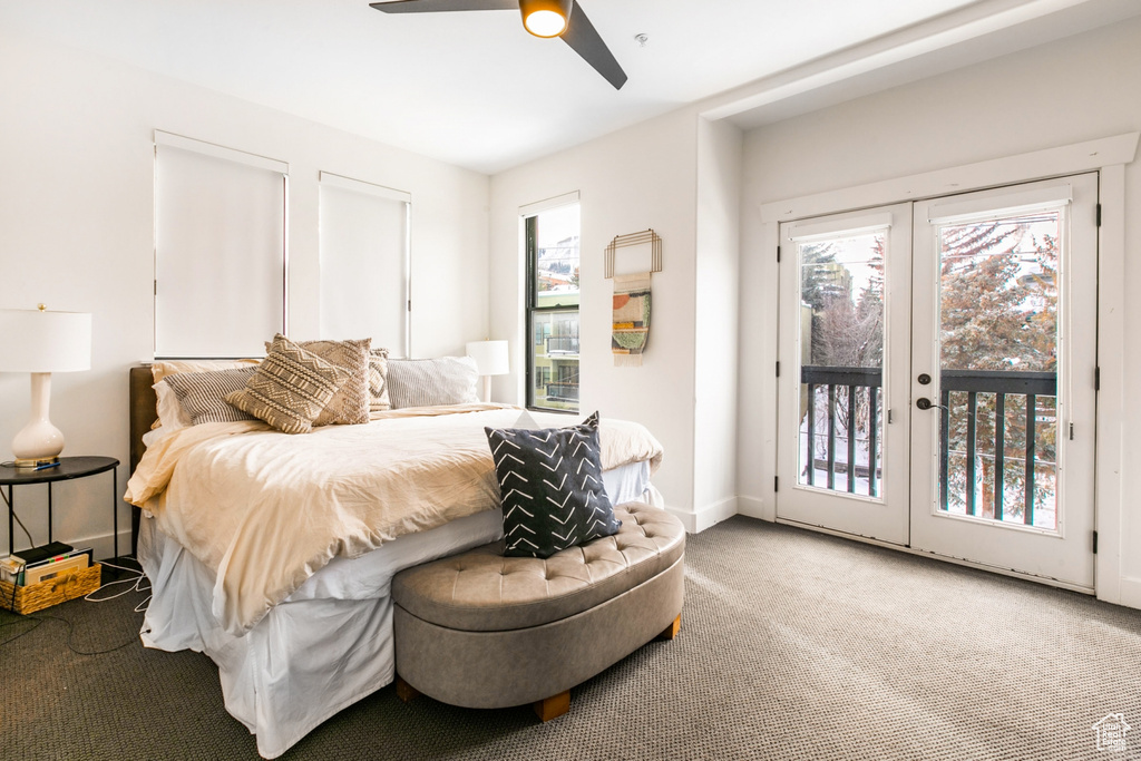 Carpeted bedroom with french doors, ceiling fan, access to outside, and multiple windows